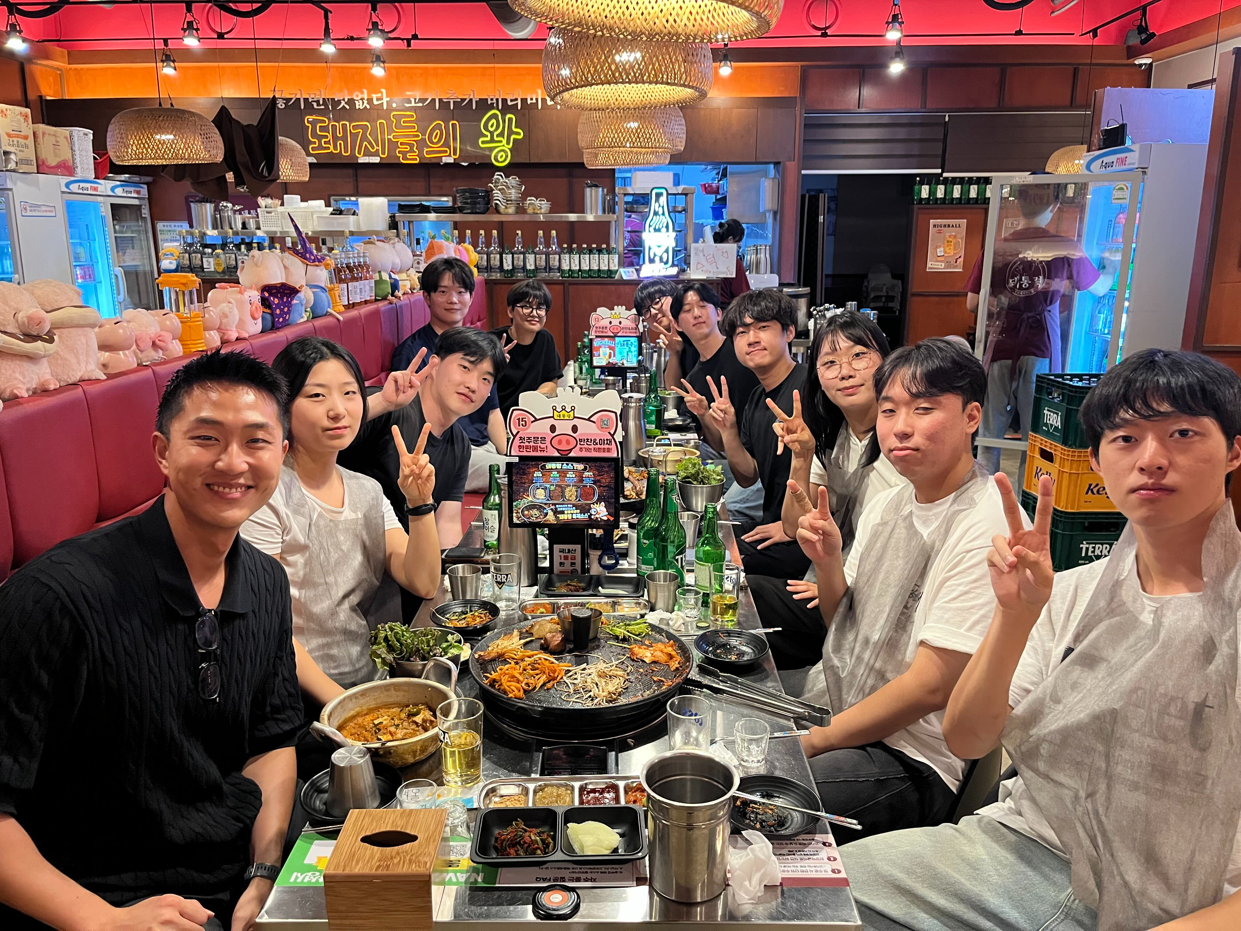 AION Lab members seated together around a restaurant table
